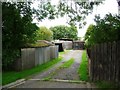 NY9672 : Track to garages and sheds by Christine Johnstone