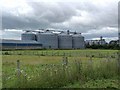 NU1233 : Grain silos at Belford Station by Oliver Dixon