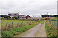 Farm track and disused farmhouse near Tore