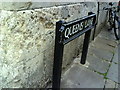 Benchmark on Queens College, behind street sign