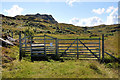NM6577 : Gate and stile near Smirisary by Steven Brown