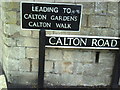 Benchmark and street signs on Calton Road junction