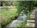 A fast flowing stream next to the A663 at Newhey