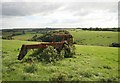 Rusty farm equipment viewed through a gateway nr Muchlarnick