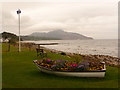 Whiting Bay: floral boat and Scottish flag alongside the shore