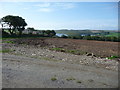 SW7526 : View over a ploughed field above the Helford River by Jeremy Bolwell