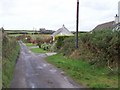 Bungalows and ruined farm buildings on Moneylane Road