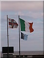 O2627 : Flags at the seafront in Sandycove by Christopher Hilton