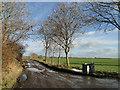 Muddy entrance to Wood Farm