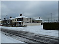 Junction of a snowy Central Road and Homefield Road