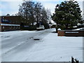 Approaching the junction of a snowy Waterworks Road and Knight Gardens