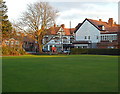 View across Hale Bowling Green to Ashley Road