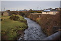 The view downstream from a bridge which carries the Tarka Trail over Knowl Water