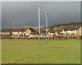 Min yr Afon houses viewed across rugby pitch, Machen