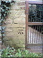 Benchmark on gatepost at entrance to St Saviour