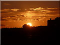 Bournemouth: sunset behind a building with a flag