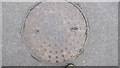 TF0820 : Round manhole in road surface, Westfield by Bob Harvey