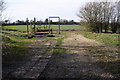 Old farm machinery stored in remnants of barn