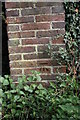 Benchmark on wall at entrance to Braziers Park