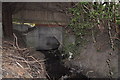 A stream passes through a culvert under the A3125 at Roundswell