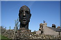 Male sculpted head at Duck Pond