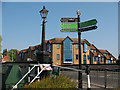 Signpost and lamppost by Brentford Bridge