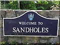 "Welcome to Sandholes", plaque