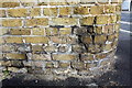 Benchmark on wall of Hunter Close at junction with Prioress Street