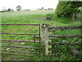 Old gate, gatepost, waymarker and stile