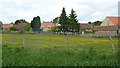 Meadow by houses in Scarcliffe