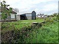 M1978 : Roadside bungalows and barn at Cloonboothy by Oliver Dixon