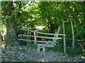 Somewhat hidden stile and signpost near Sloop Lane