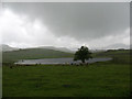 NY3023 : Tewet Tarn in a rainstorm by Stephen Craven