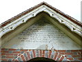 Inscription above the church porch at St Peter