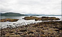 NG8038 : Rocky foreshore by Toby Speight