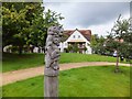 Wooden sculpture on the "village green" of Henderson Avenue