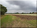 Newly ploughed fields under storm clouds