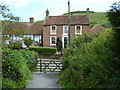 Footpath from the north arrives at The Street in Fulking