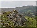 A humanoid rock outcrop above Ballmaginaghy Road