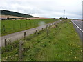 Farm track servicing the field beside the busy A96