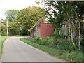 Rural lane past sheds at Rookery Farm, Chippenhall Green