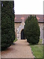 TM3046 : Entrance path & Porch of All Saints Church, Sutton by Geographer