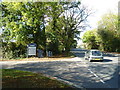 Car passing the turning for the Golf Driving Range in Chestnut Avenue