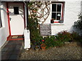 Board outside a cottage in Cwmtydu