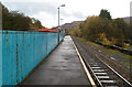 Blue fence at the edge of a river, Ton Pentre railway station