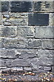 Benchmark on the wall of Huddersfield Road