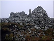 NY6055 : Cold Fell shelter, trig point and cairn by Andrew Curtis