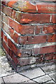 Worn benchmark on the Customs House, Castletown