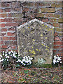 Gravestone against a brick wall, St Martin