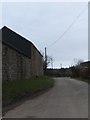 Minor road at Eastacott passing farm buildings